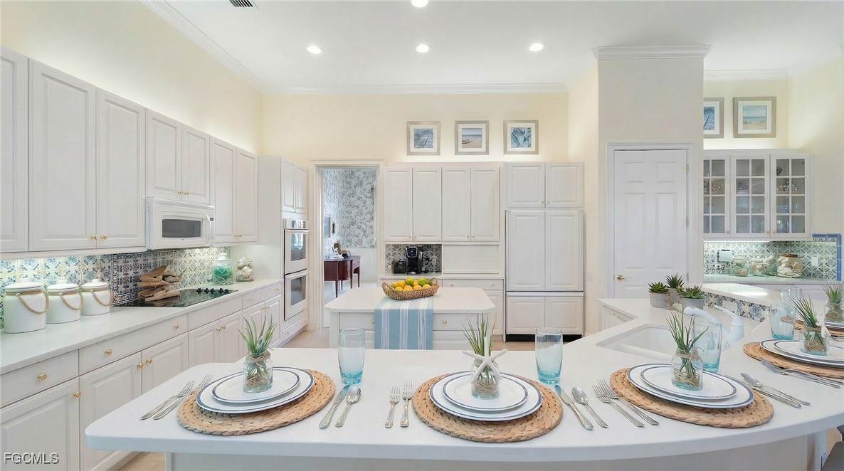 11511 Compass Point Drive Fort Myers, FL 33908 - Photo 11 of 46 a kitchen with dining table and chairs