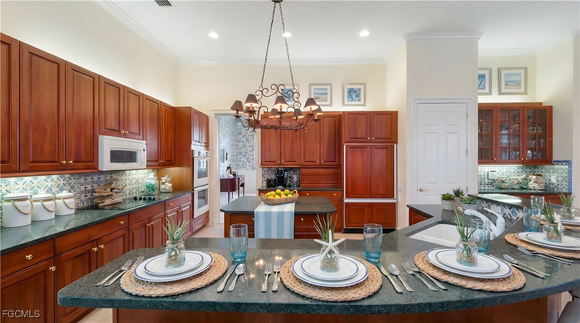 11511 Compass Point Drive Fort Myers, FL 33908 - Photo 12 of 46 a view of a dining room with furniture a chandelier and wooden floor
