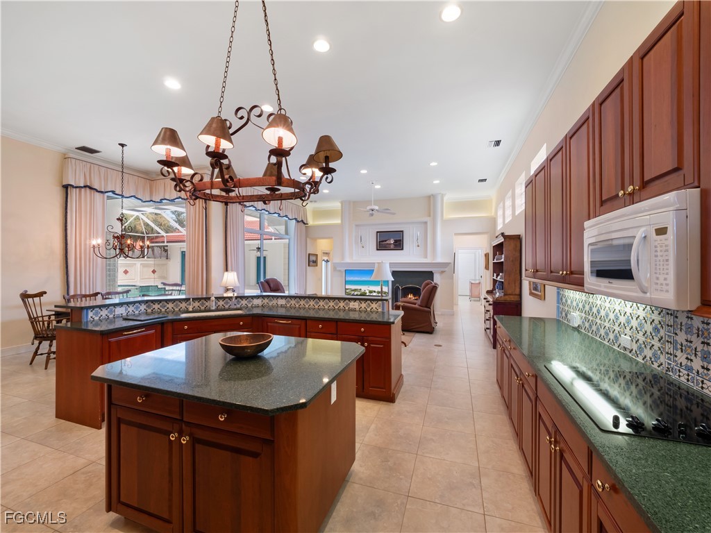 11511 Compass Point Drive Fort Myers, FL 33908 - Photo 13 of 46 a kitchen with stainless steel appliances granite countertop a sink a stove and a wooden floors