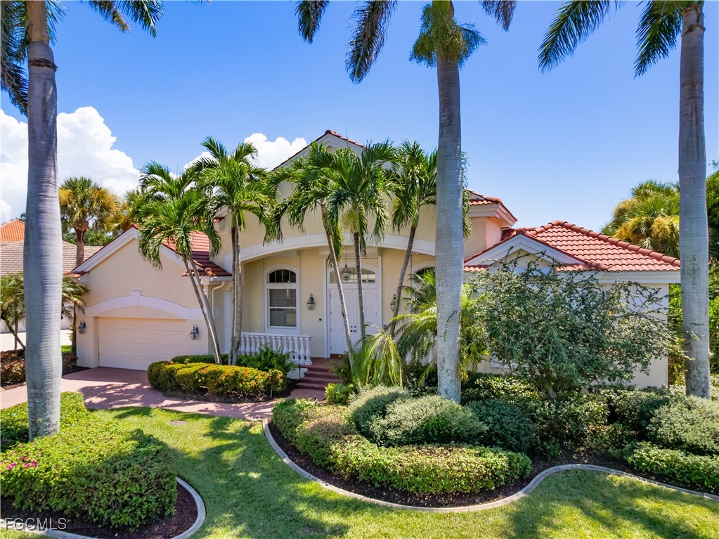 11511 Compass Point Drive Fort Myers, FL 33908 - Photo 2 of 46 a front view of a house with garden