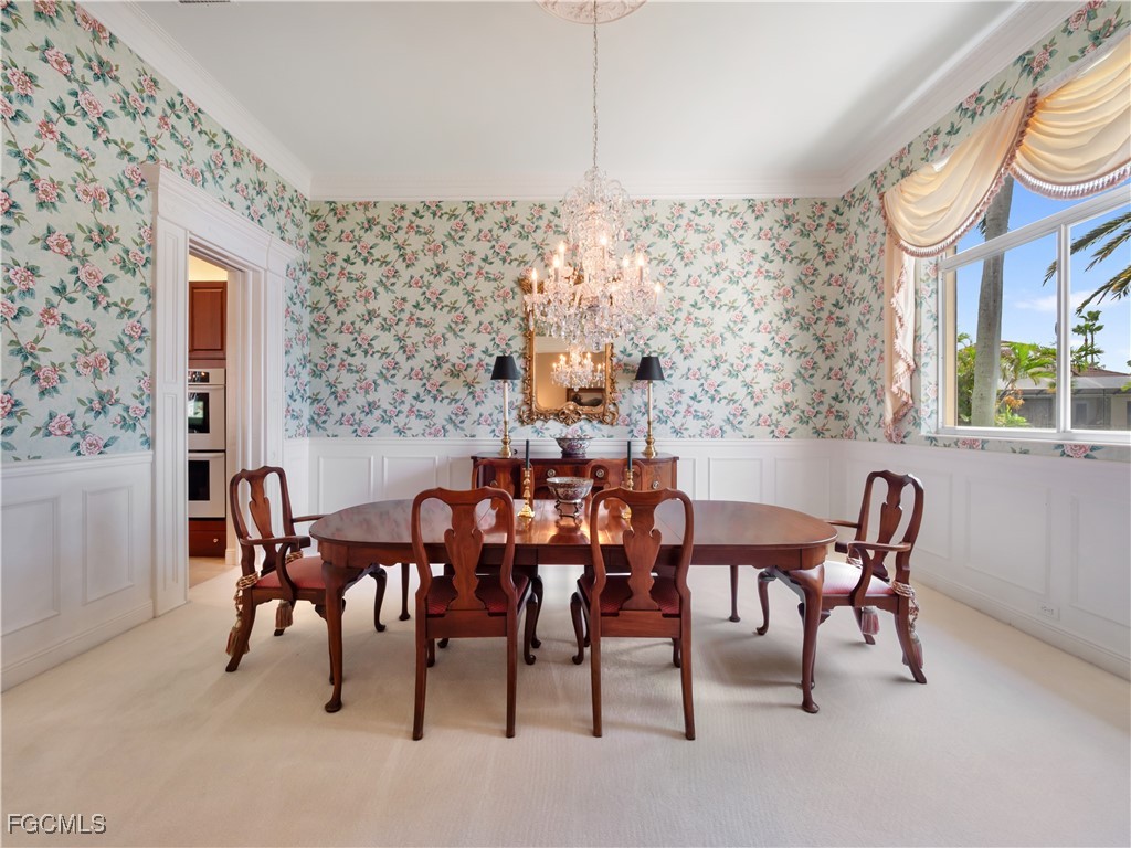 11511 Compass Point Drive Fort Myers, FL 33908 - Photo 21 of 46 a view of a dining room with furniture and chandelier
