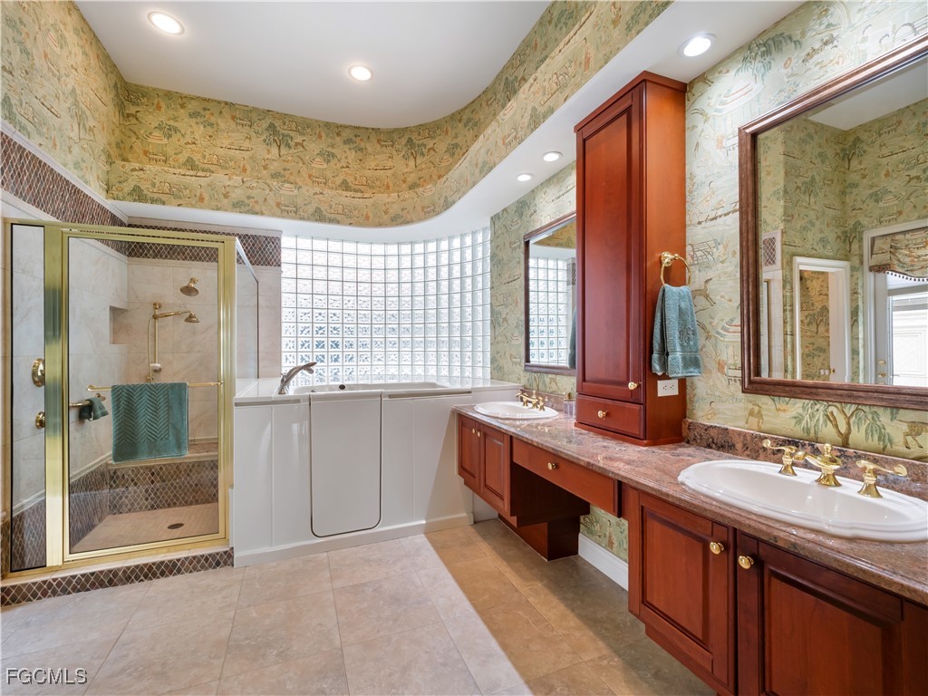 11511 Compass Point Drive Fort Myers, FL 33908 - Photo 25 of 46 a large bathroom with double vanity and a large mirror