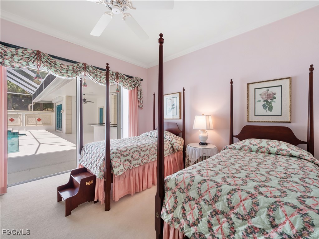 11511 Compass Point Drive Fort Myers, FL 33908 - Photo 27 of 46 a bedroom with a bed and a chandelier