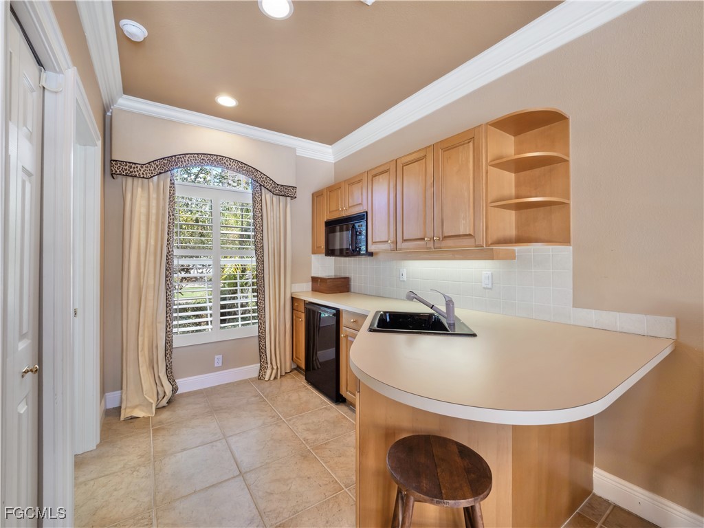 11511 Compass Point Drive Fort Myers, FL 33908 - Photo 35 of 46 a kitchen with a sink a stove and a refrigerator