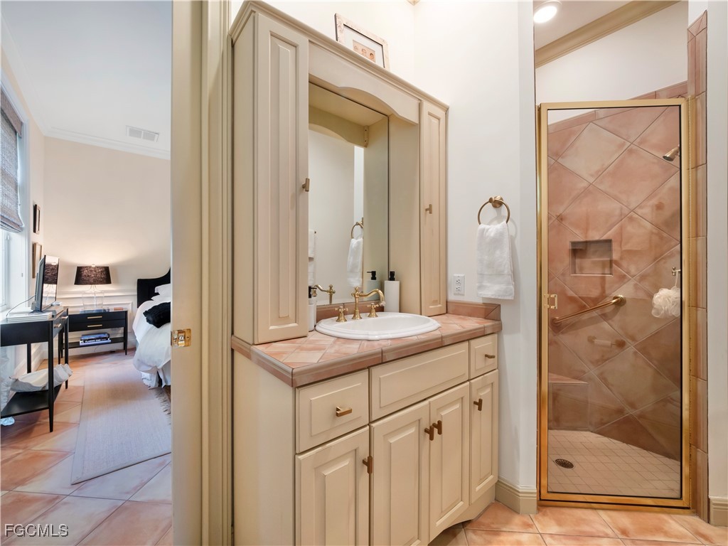 11511 Compass Point Drive Fort Myers, FL 33908 - Photo 40 of 46 a en suite bathroom with a shower sink and mirror