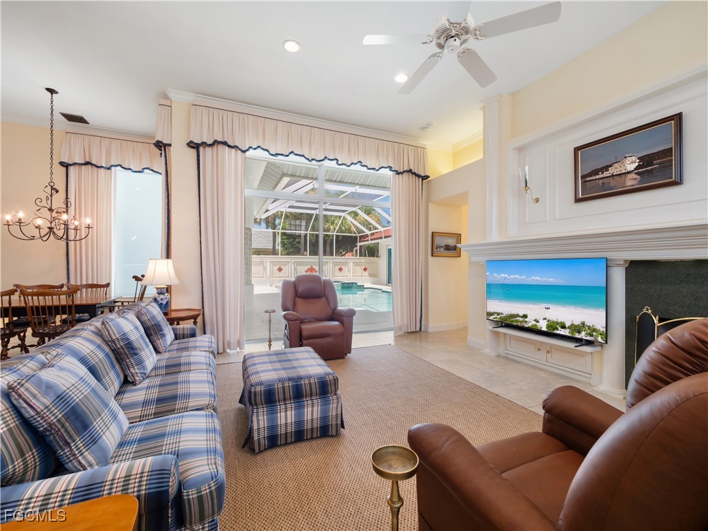 11511 Compass Point Drive Fort Myers, FL 33908 - Photo 7 of 46 a living room with furniture and a fireplace