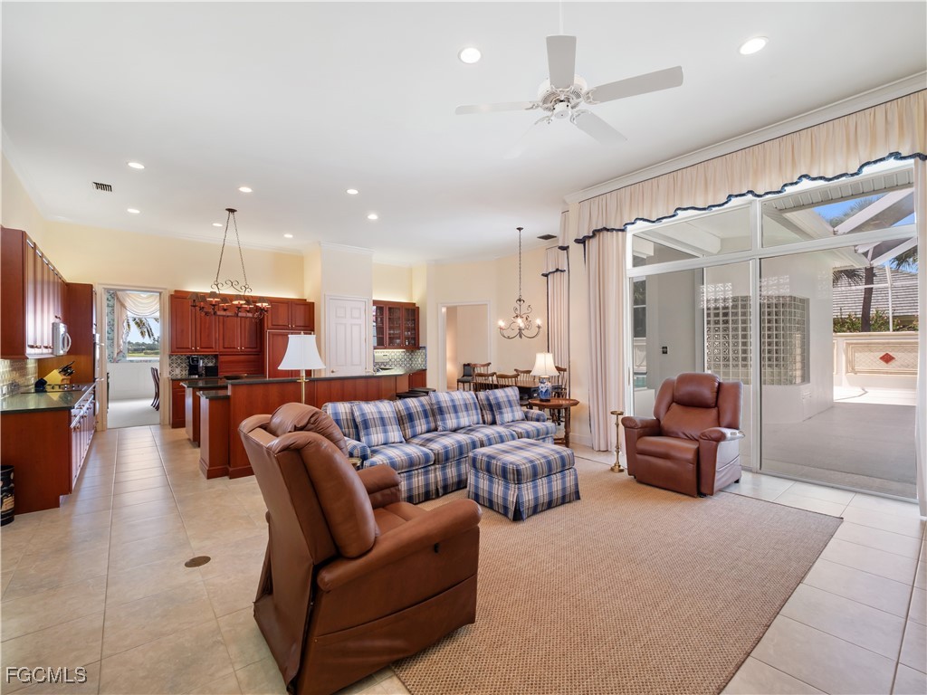 11511 Compass Point Drive Fort Myers, FL 33908 - Photo 8 of 46 a living room with furniture kitchen view and a chandelier
