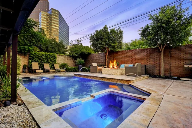 a view of an empty room with a fireplace and a window