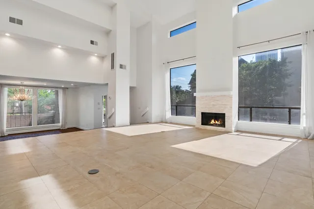 an empty room with a fireplace and window