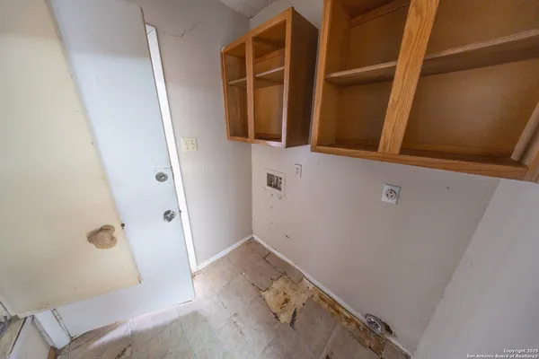 a room with a bed and a kitchen