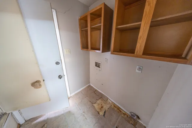 a room with a bed and a kitchen