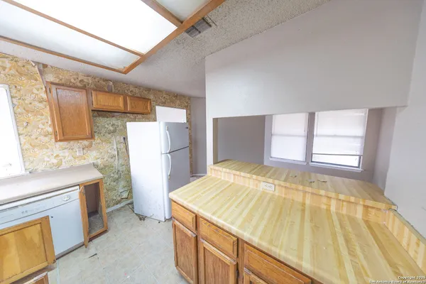 a view of a bedroom with wooden floor and windows