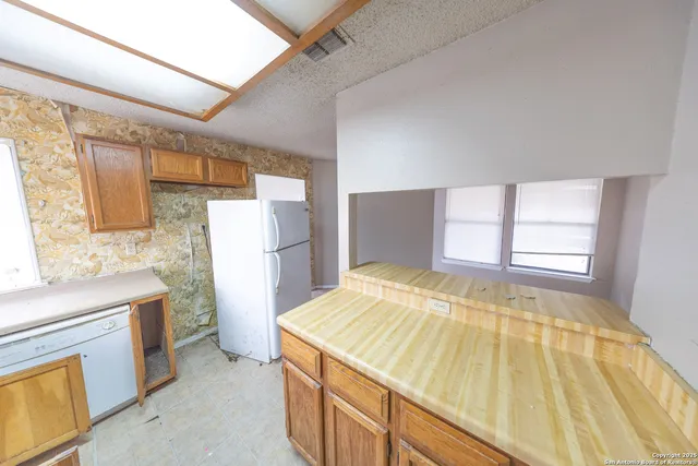 a view of a bedroom with wooden floor and windows