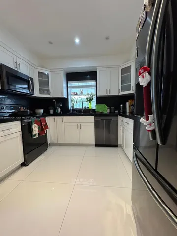a kitchen with stainless steel appliances a stove sink and microwave
