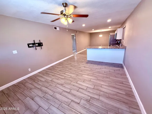 a view of a kitchen with a dishwasher cabinets and wooden floor