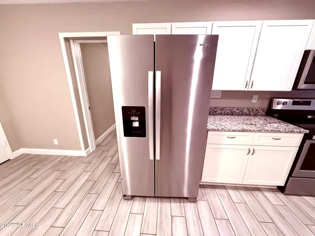 a kitchen with a refrigerator and a stove