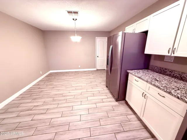 a kitchen with stainless steel appliances granite countertop a refrigerator and a sink