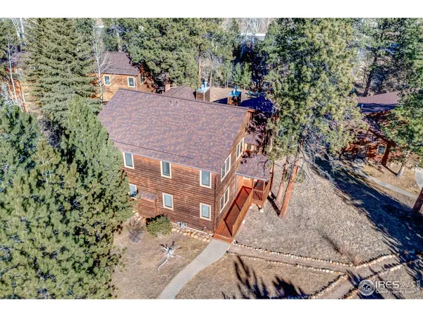 a aerial view of a house with a yard basket ball court and outdoor seating