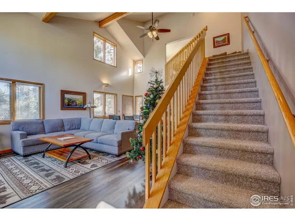 a view of a livingroom with furniture and staircase