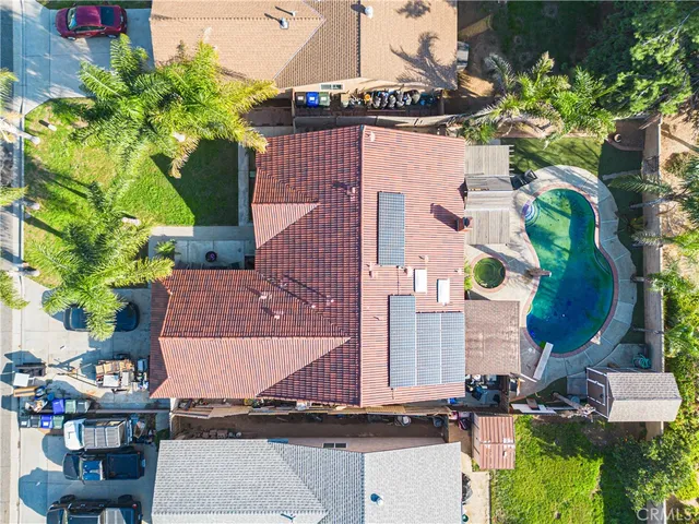 an aerial view of a house with yard swimming pool and outdoor seating