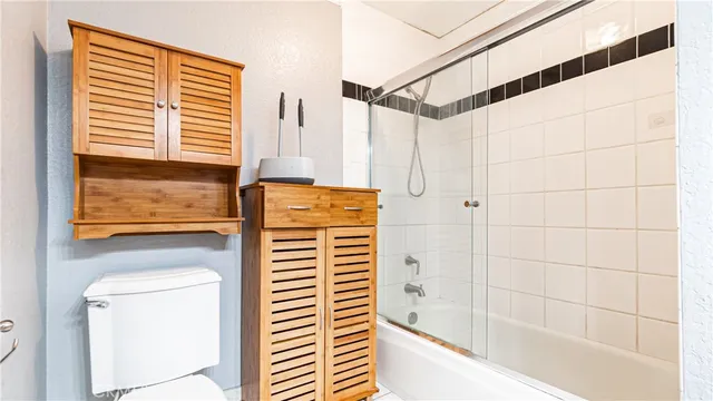 an empty room with wooden floor and closet