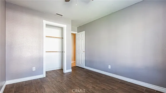 a bedroom with a bed and glass walk in closet
