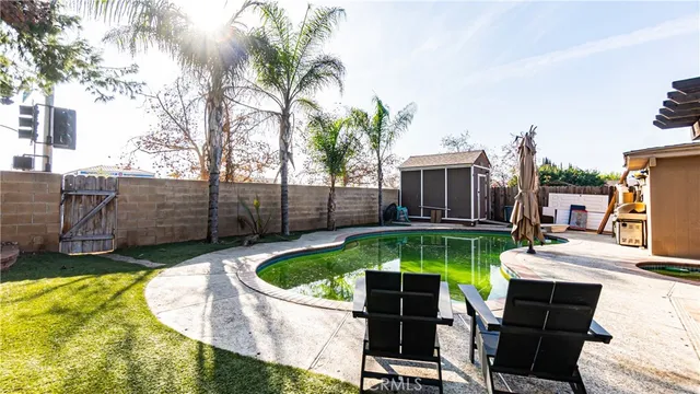 a view of a patio with swimming pool table and chairs