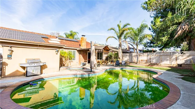 a view of a house with swimming pool and sitting area