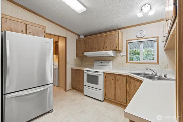 a white refrigerator freezer sitting inside of a kitchen