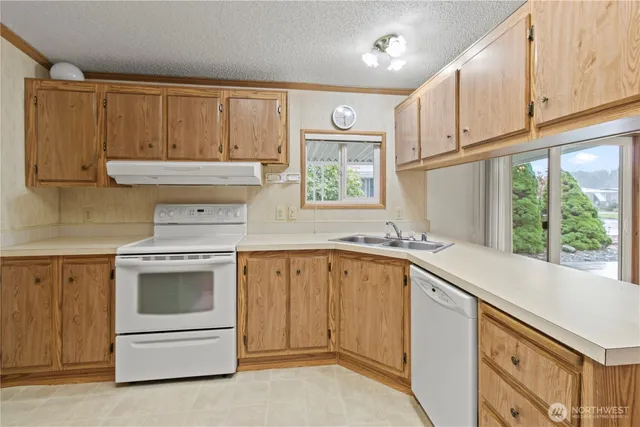 a kitchen with a sink stove and cabinets