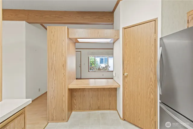 a view of a hallway with wooden floor and a living room