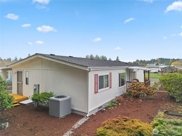 a view of a house with a patio and a yard