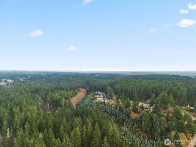 a view of a lake and green valley