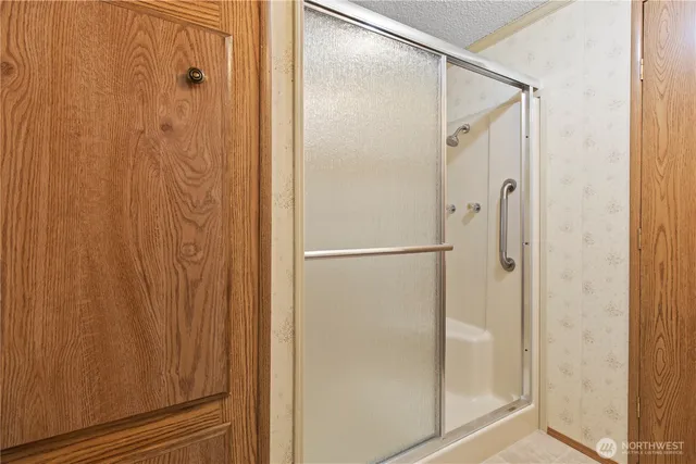 a bathroom with a glass shower door