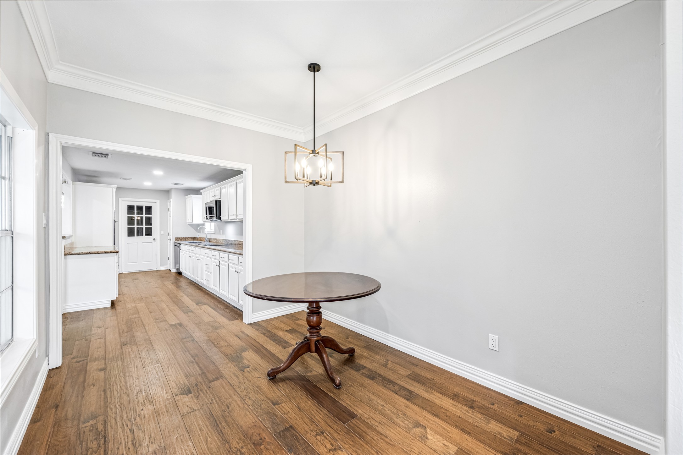 9806 Tanager Lane Conroe, TX 77385 - Photo 13 of 28 a view of a room with wooden floor table and chairs
