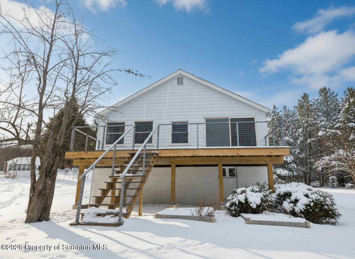 915 Sugar Hollow Road Tunkhannock, PA 18657 - Photo 1 of 48 a view of a white house with a bench and potted plants