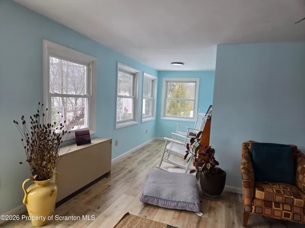 a kitchen with stainless steel appliances granite countertop a stove a refrigerator a kitchen island and chairs in it