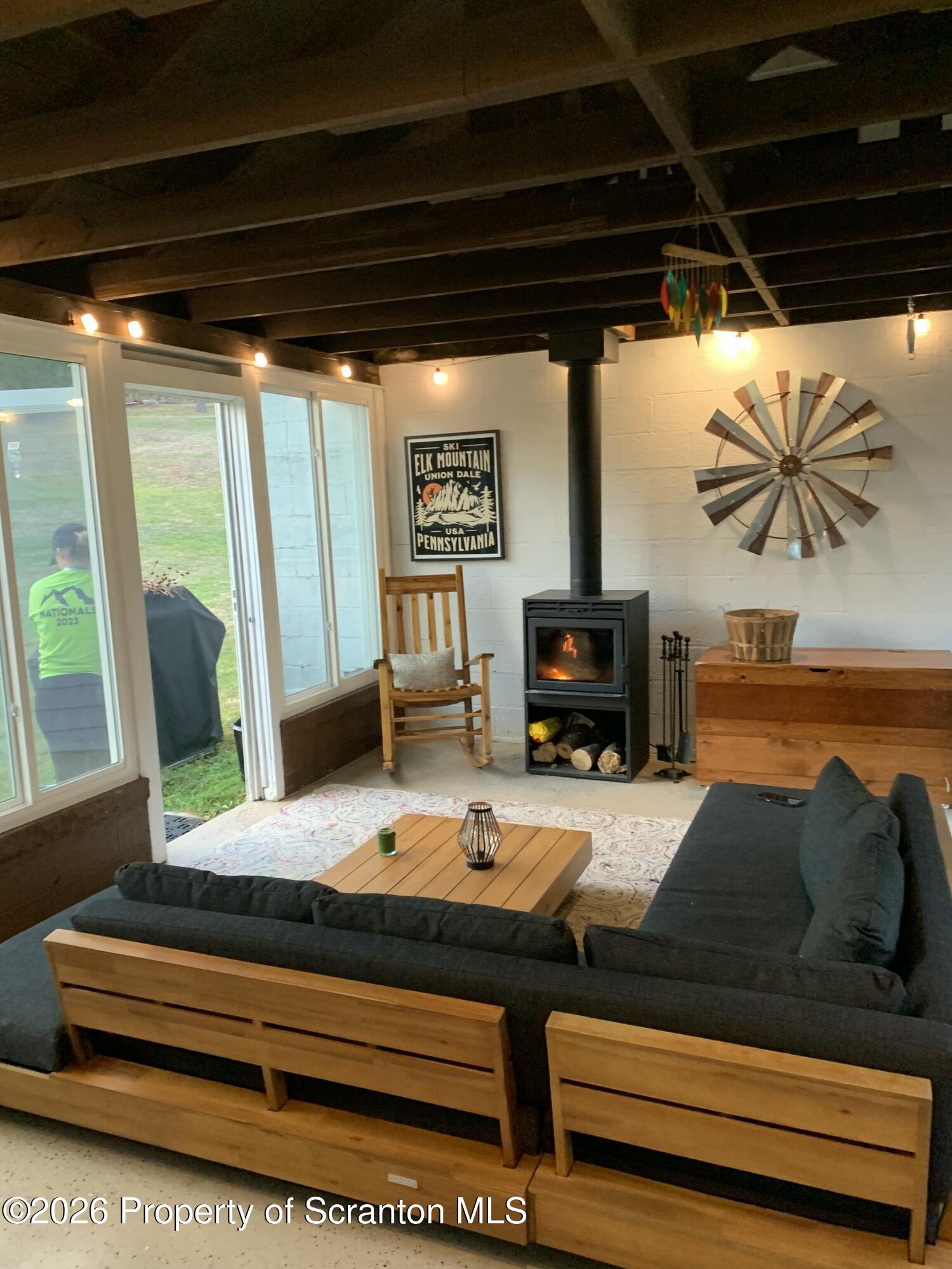 915 Sugar Hollow Road Tunkhannock, PA 18657 - Photo 20 of 48 a living room with furniture a fireplace and a floor to ceiling window