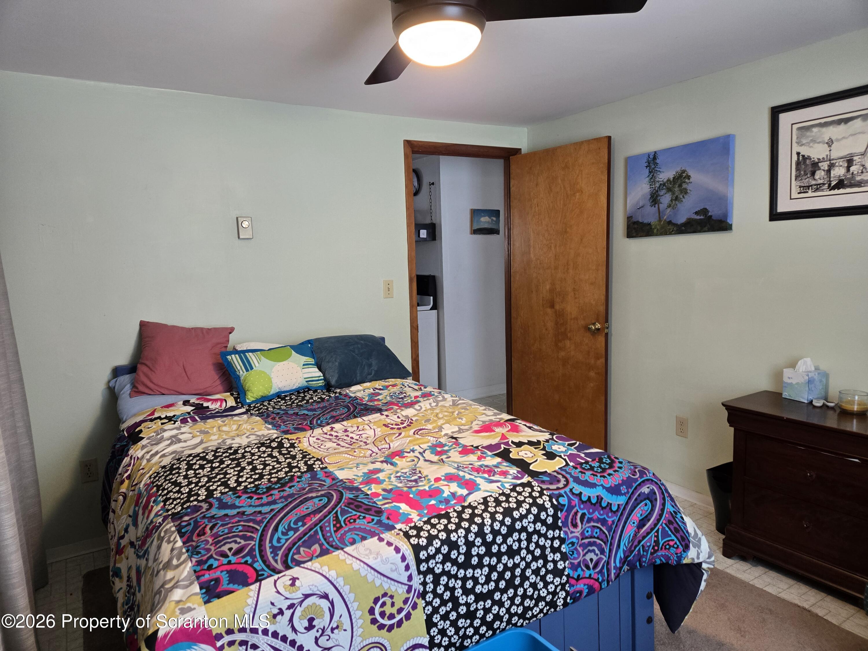 915 Sugar Hollow Road Tunkhannock, PA 18657 - Photo 25 of 48 a bedroom with a bed and a lamp on dresser