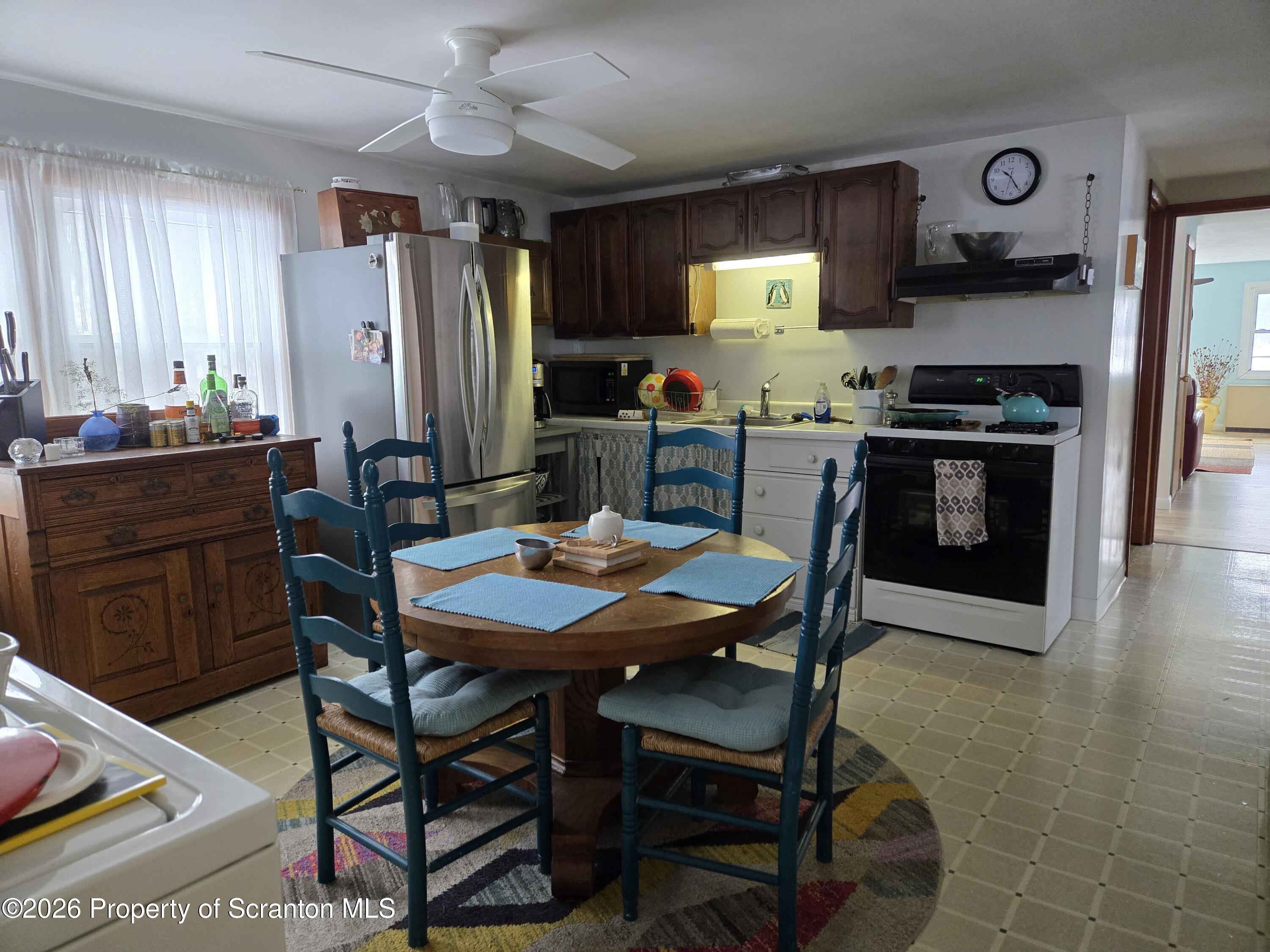915 Sugar Hollow Road Tunkhannock, PA 18657 - Photo 26 of 48 a kitchen with stainless steel appliances granite countertop a stove a refrigerator a kitchen island and chairs in it