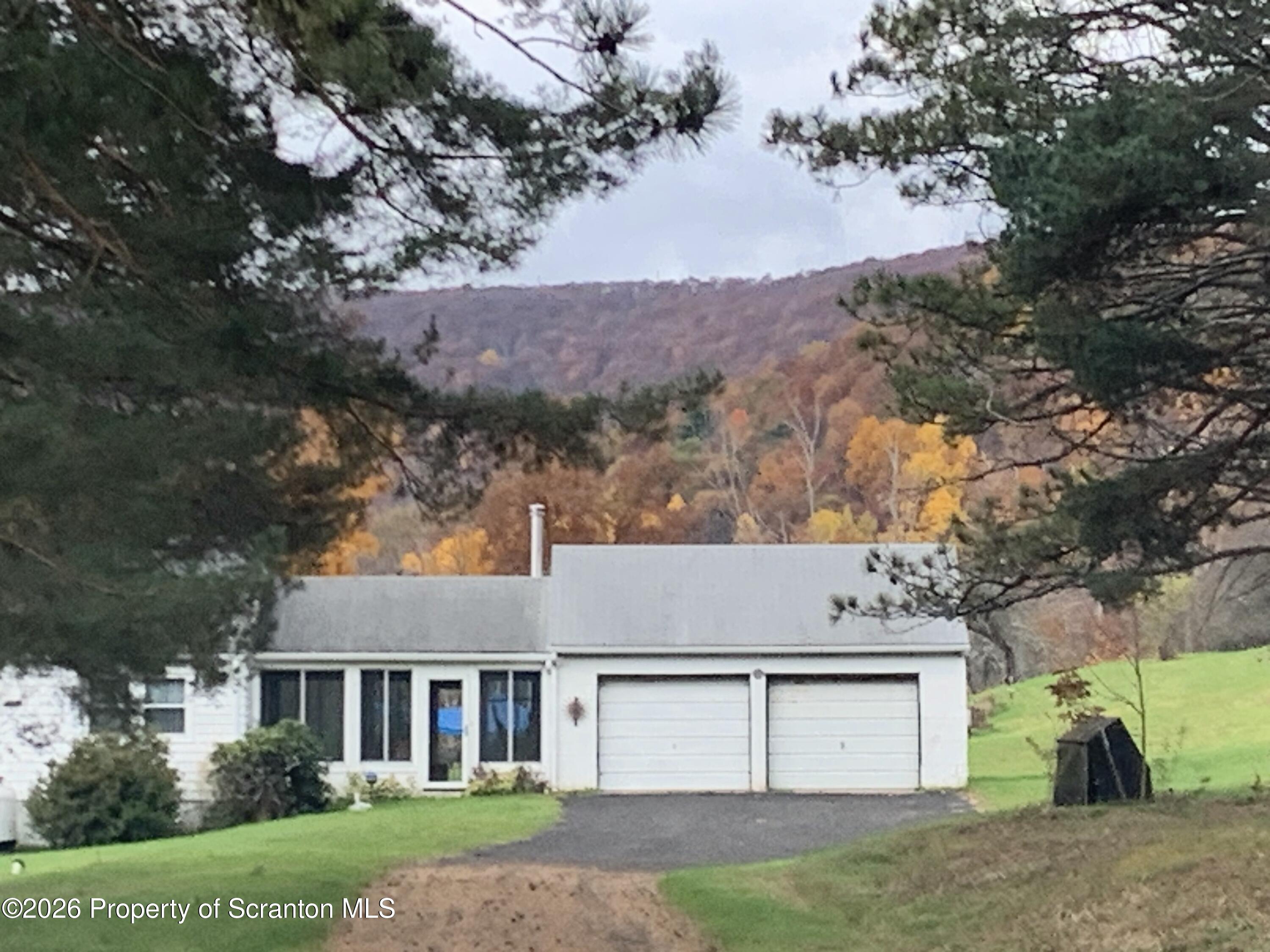 915 Sugar Hollow Road Tunkhannock, PA 18657 - Photo 5 of 48 a view of a yard in front of a house with large tree