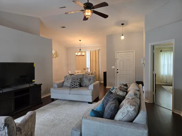 a living room with furniture and a flat screen tv