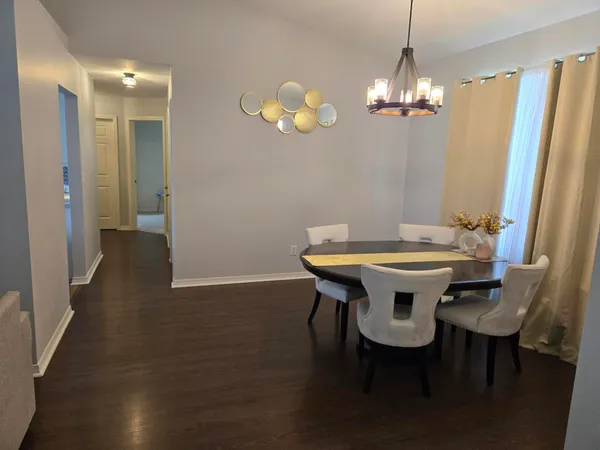 a view of a dining room with furniture and chandelier