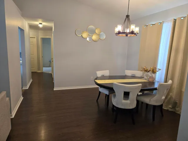 a view of a dining room with furniture and chandelier