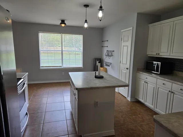 a kitchen with a sink a counter space and appliances