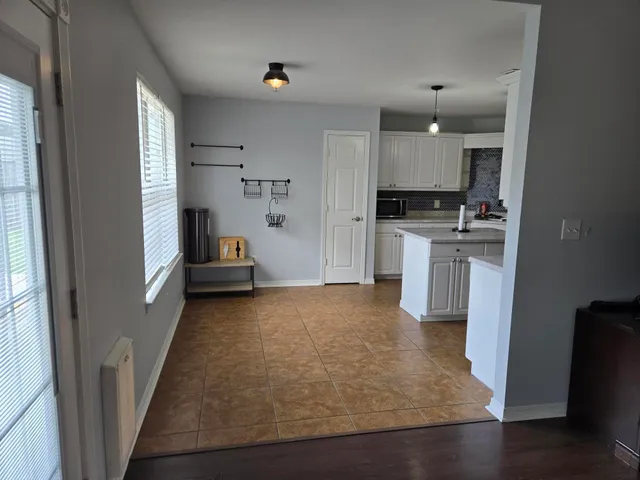 a view of kitchen with sink and refrigerator