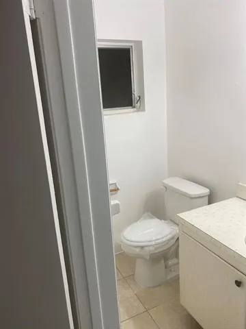 a white toilet sitting next to a sink