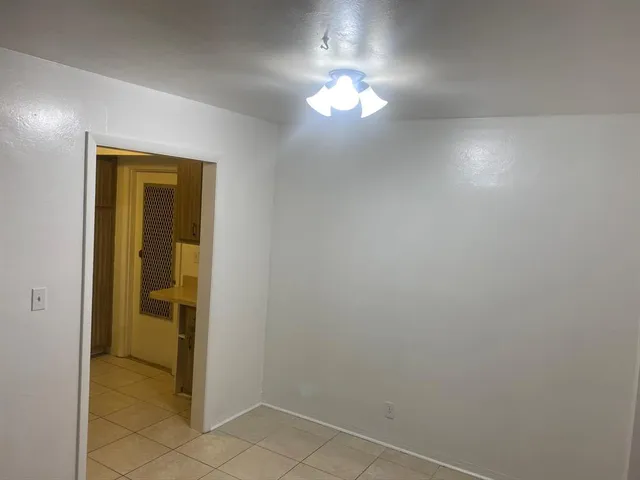 a view of a chandelier fan and fire place