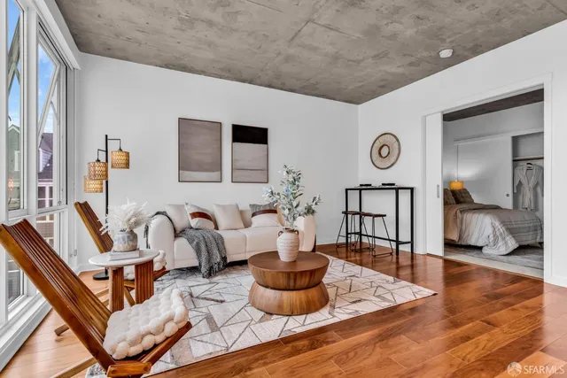 a living room with furniture and a wooden floor
