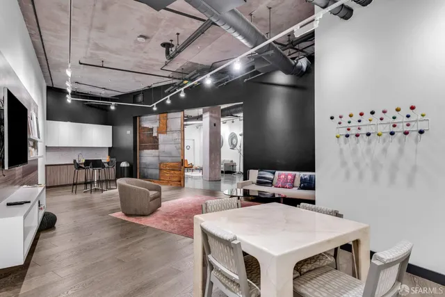 a living room with furniture a chandelier and a window